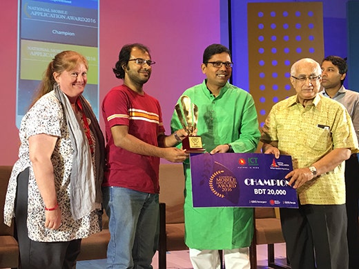 Group of people on stage accepting Champion Award.