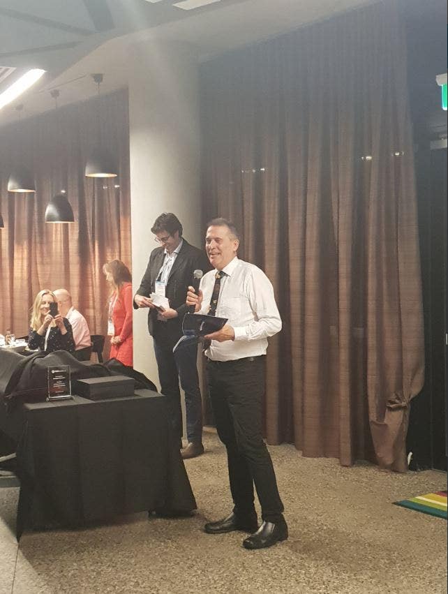 Emeritus Professor David Rowe with his award.