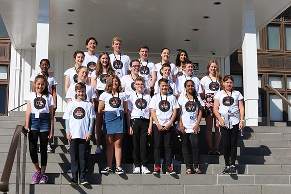 A group of young people on the steps of the Museum of Australian Democracy
