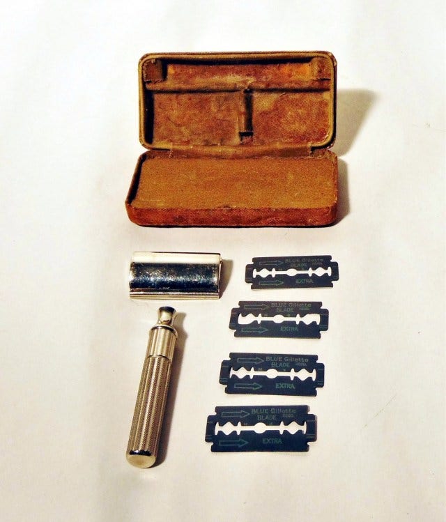A 1932 Gillette shaving razor with three blades and storage box.