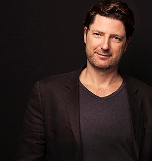 Professor Juan Francisco Salazar against a brown background.