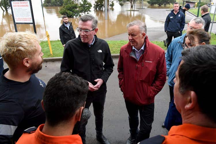 Two politicians – Dominic Perrotet and Anthony Albanese – talk with residents affected by floods