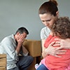 A man, woman and child looking distressed.