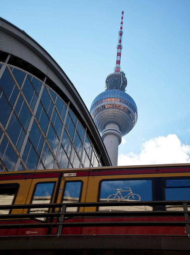 skyscraper against a blue sky and train station