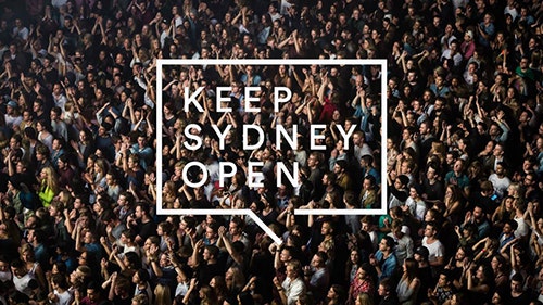 Photo looking down on a crowd at night with the Keep Sydney Open white logo over it (a rectangle with a small section of the bottom line open on an angle).
