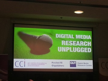 Presentation slide reading Digital Media Research Unplugged with a picture of a microphone.