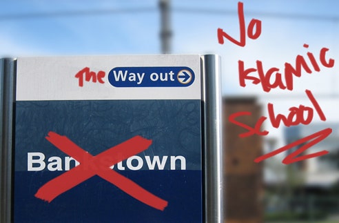 A Bankstown station sign which has been written over in red writing now reads 'No Islamic school'.