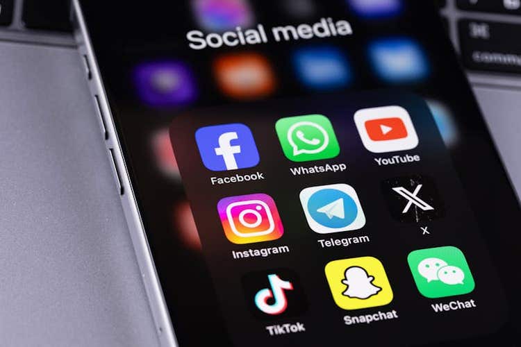 Smartphone with social media app icons.