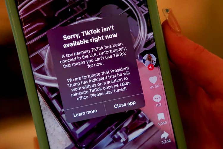 A phone screen showing a message that says tiktok isn't available right now.