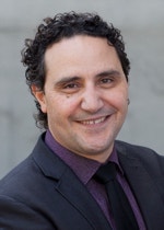Dr James Arvanitakis with trees and the Female Orphan School in the background.