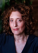 Dr Alana Lentin with trees in the background.