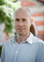 Professor Ned Rossiter with trees and the Female Orphan School in the background.