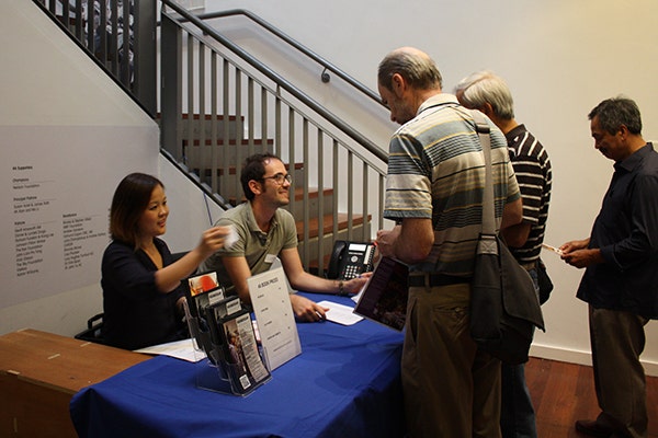 Guests register at the Chinatown symposium