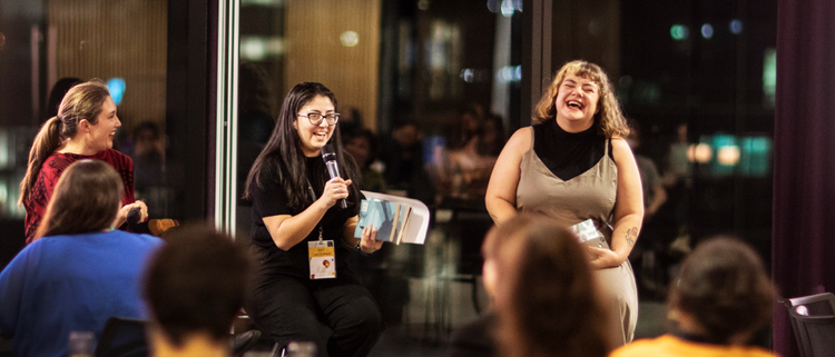 Three women speaking at an event