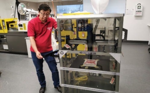 Richard Yang pictured with re:3D Inc printer