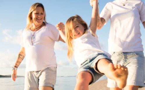 Lesbian couple with child on the beach