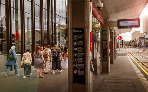 People walking past Light Rail stop at Parramatta Square