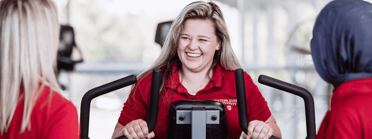 School of Health Sciences students with gym equipment.