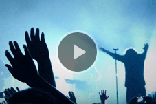 Person preaching with audience in foreground