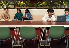 Group of western sydney students talking and using computer