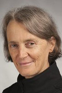 picture of a woman with grey short hair wearing a black skivvy